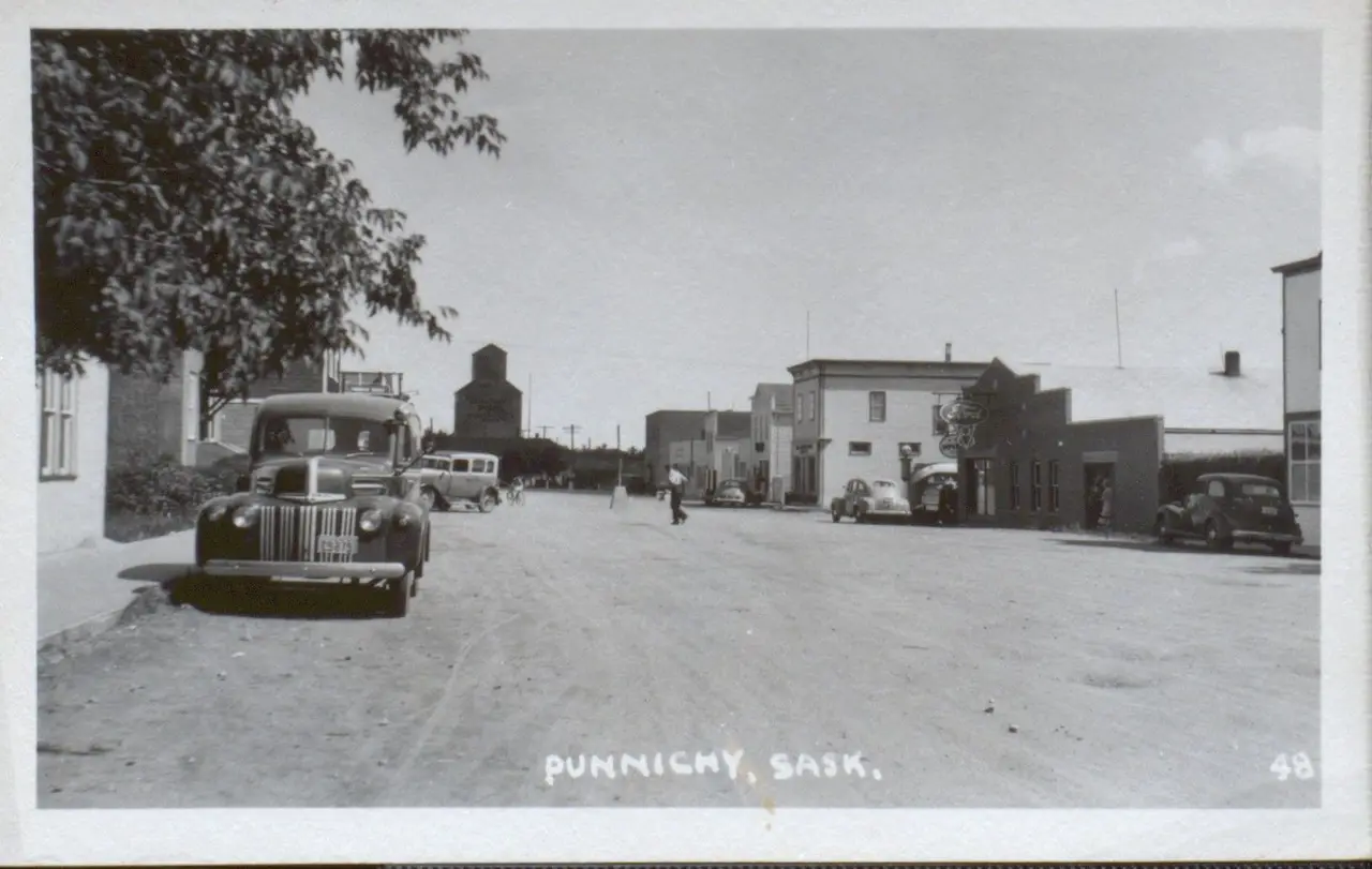 Street scene with grain elevator, about 1940s